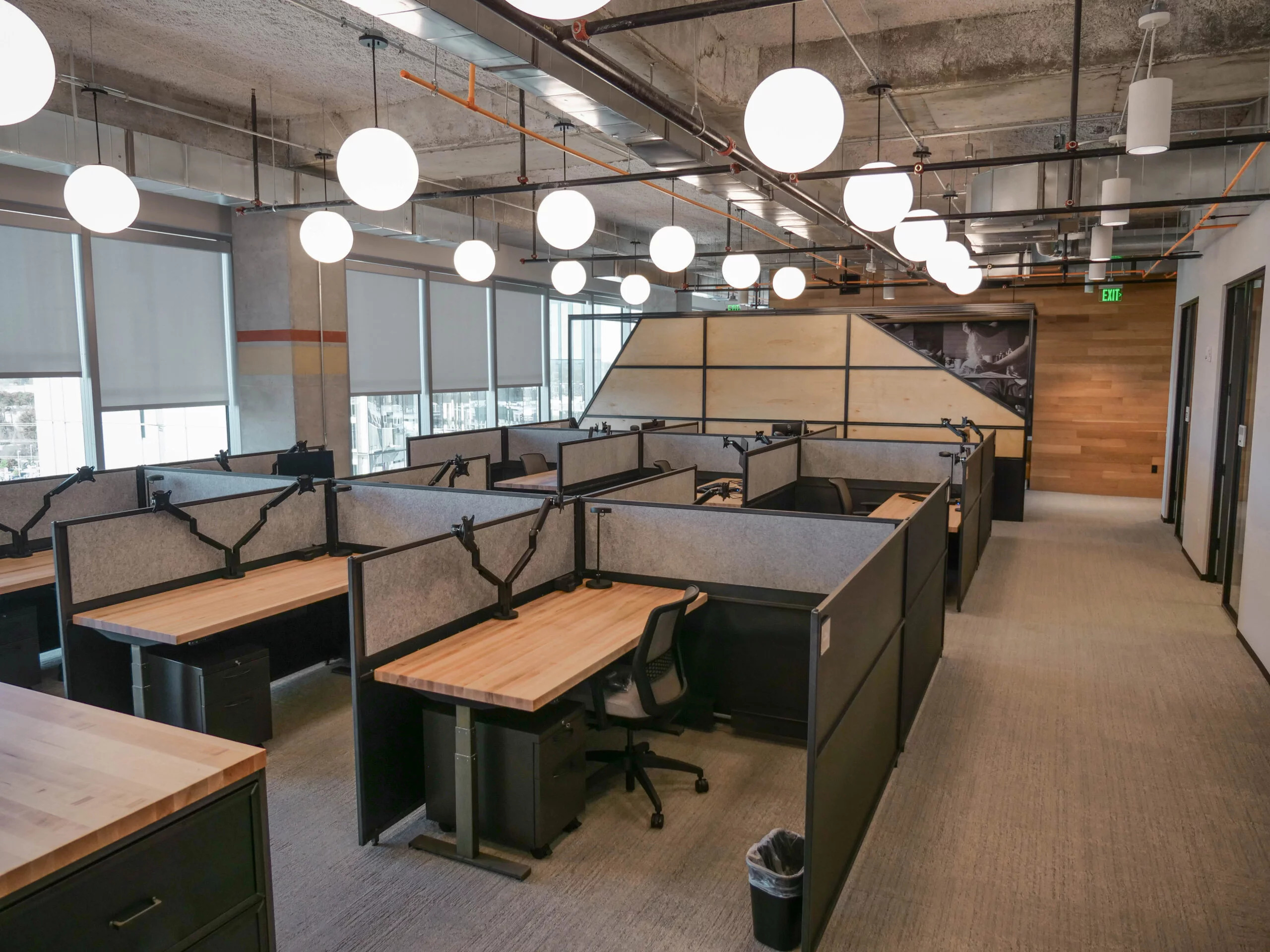 Iron Age coworking desking system arranged in an open office workspace environment
