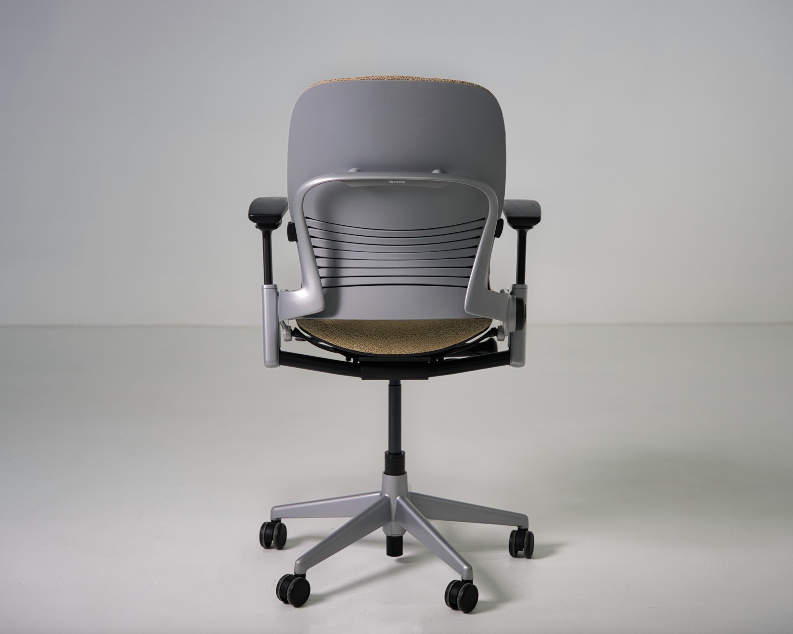 Refurbished Steelcase Leap V2 ergonomic chair in tan patterned fabric back view